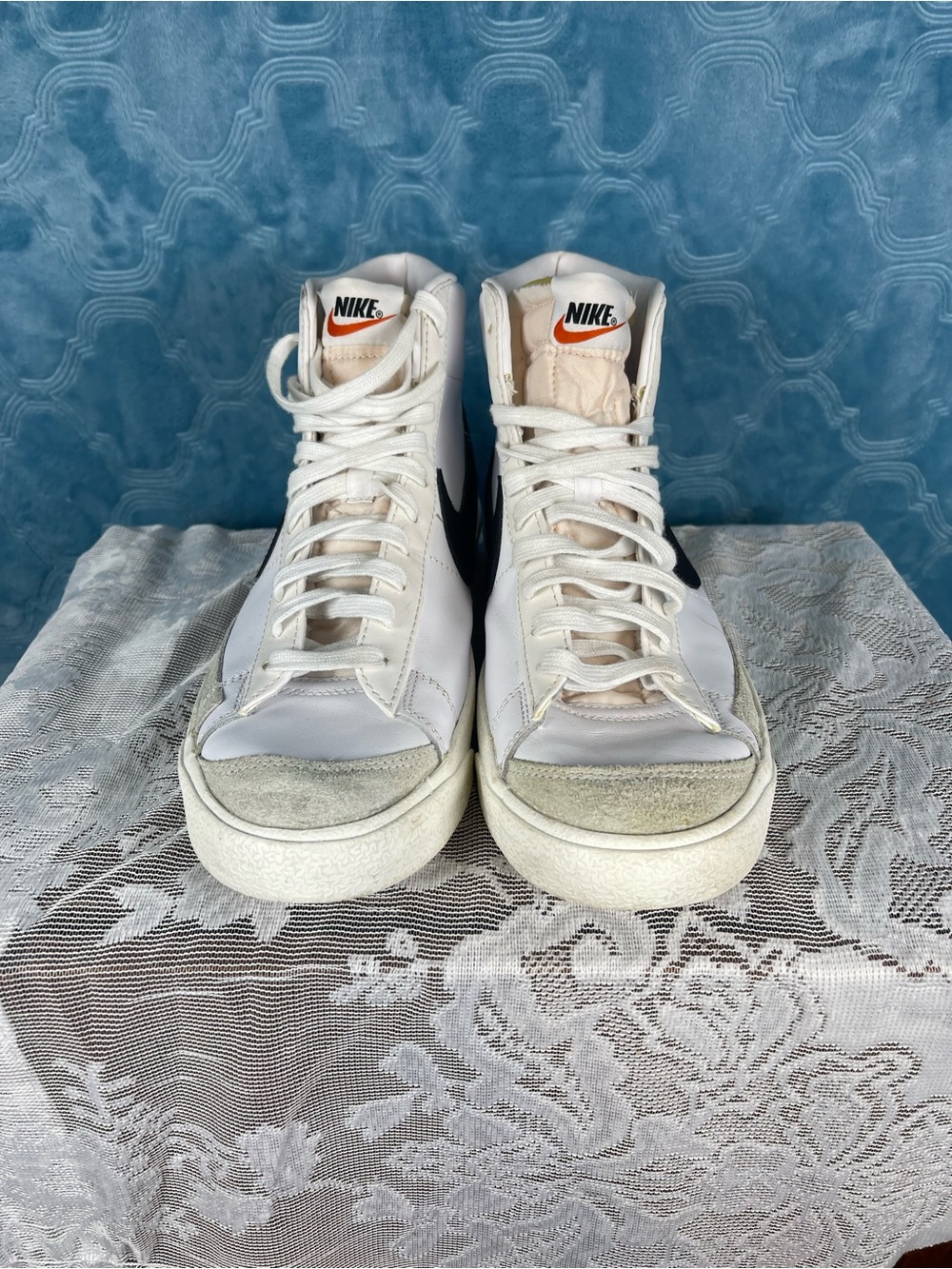 Nike White High-Top Sneakers with Black Swoosh and Orange Tongue Logo
